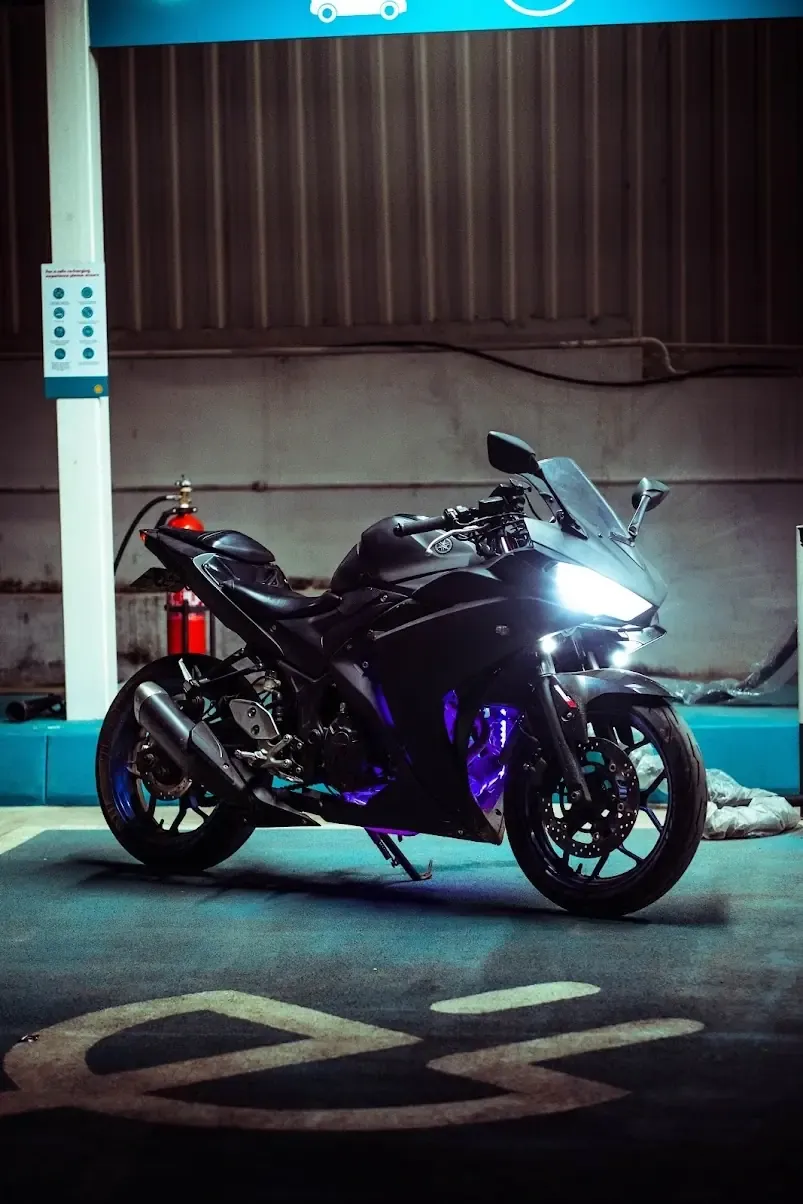 Black Suzuki GSX sportbike with custom lighting in parking structure
